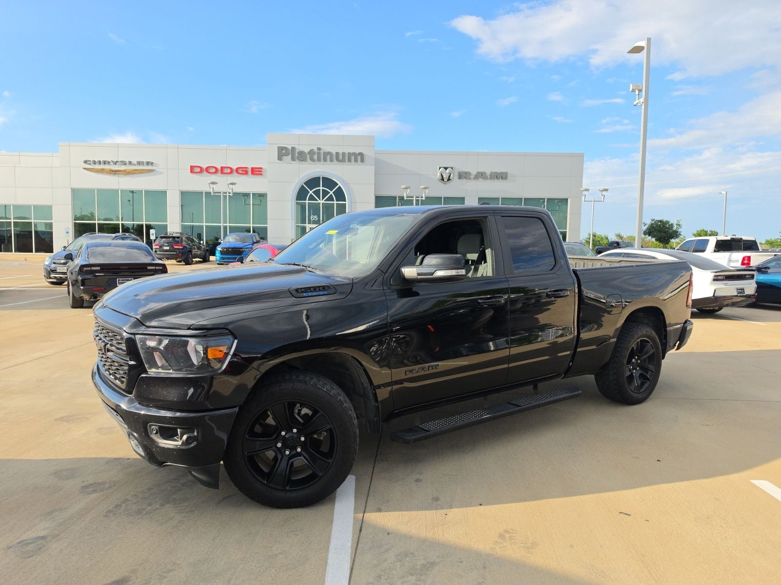 2022 RAM Ram 1500 Lone Star Quad Cab 4x4 6'4' Box in Diamond Black Crystal Pearlcoat — front three-quarter view