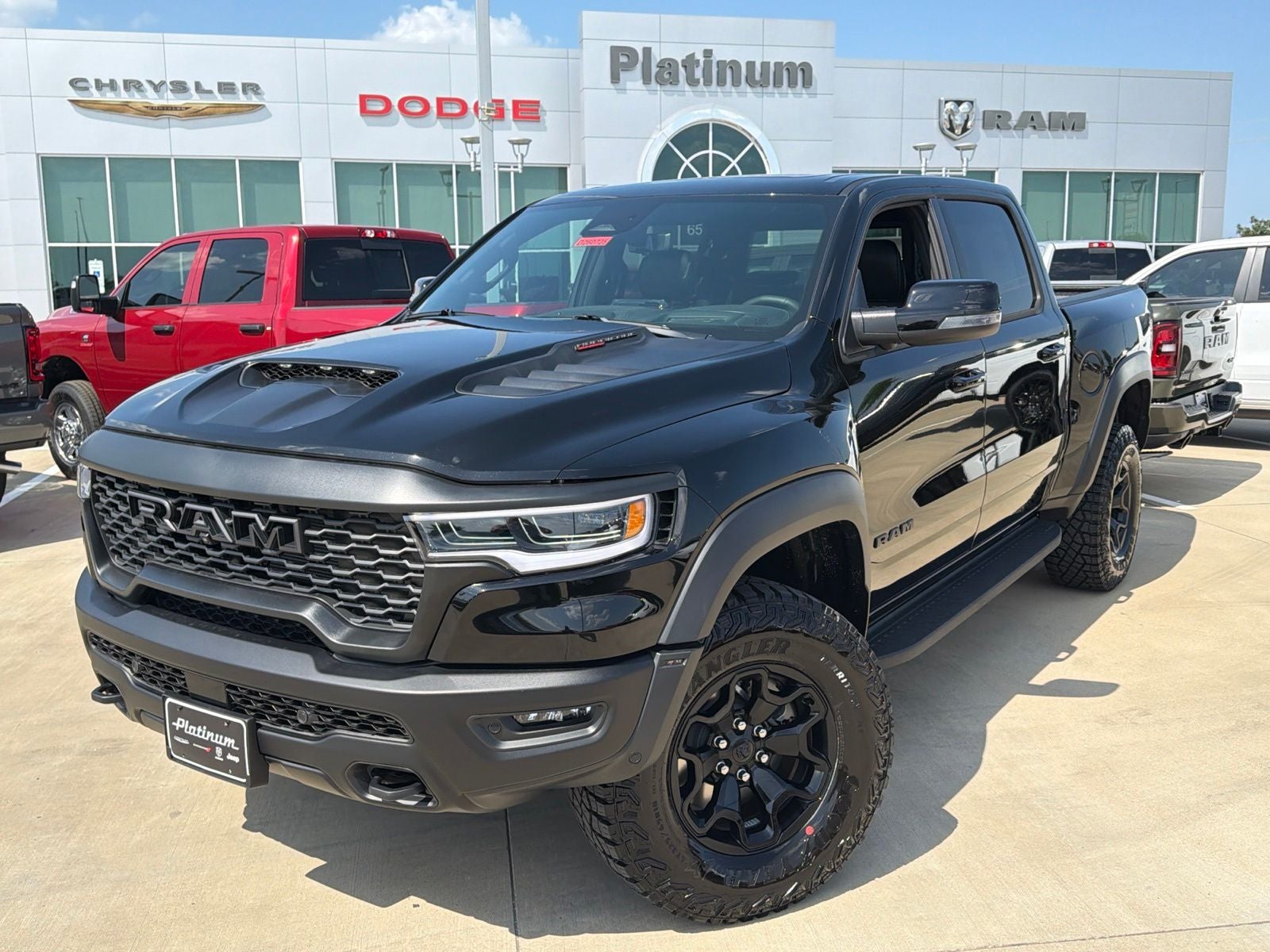 2026 RAM Ram 1500 RAM 1500 RHO CREW CAB 4X4 5'7' BOX in Diamond Black Crystal Pearl-Coat Exterior Paint — front three-quarter view