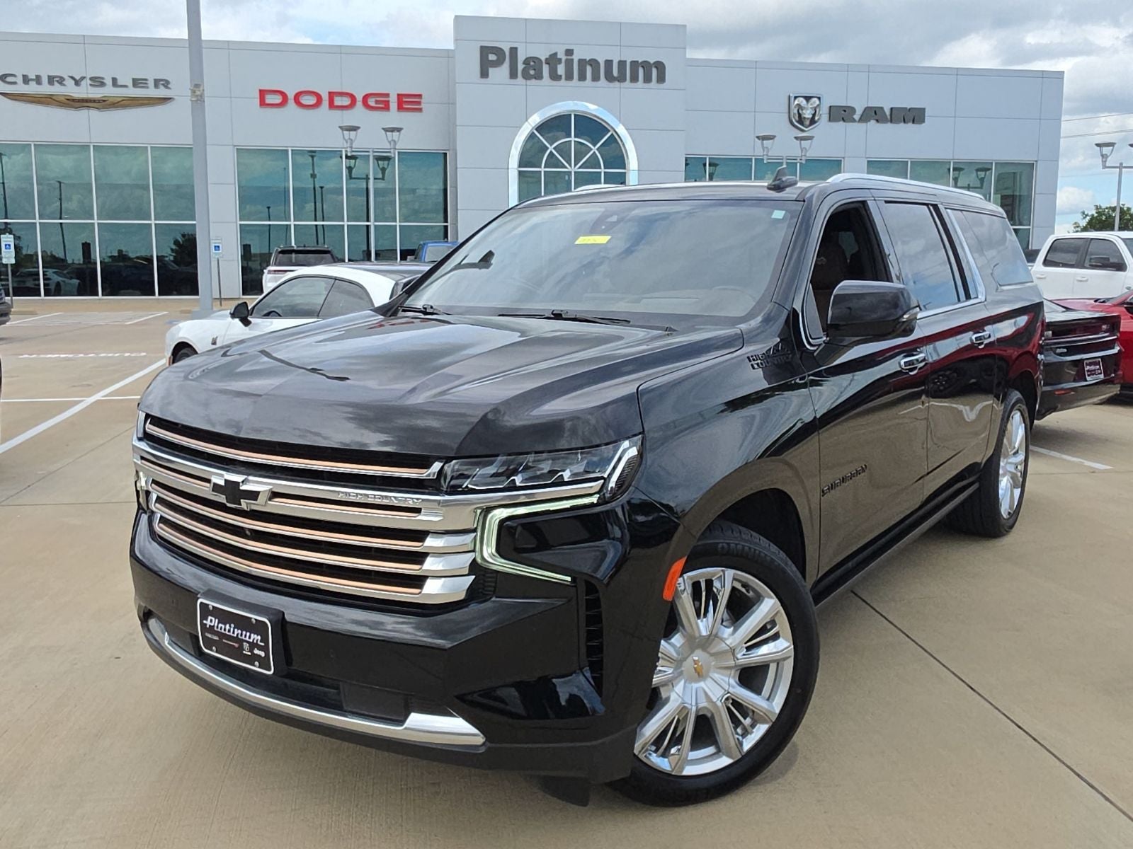 2022 Chevrolet Suburban 4WD High Country in Black — front three-quarter view