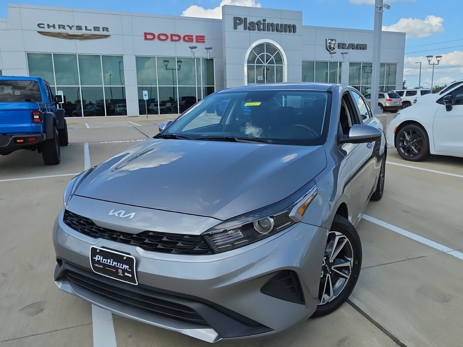 2024 Kia Forte LXS in Steel Gray — front three-quarter view