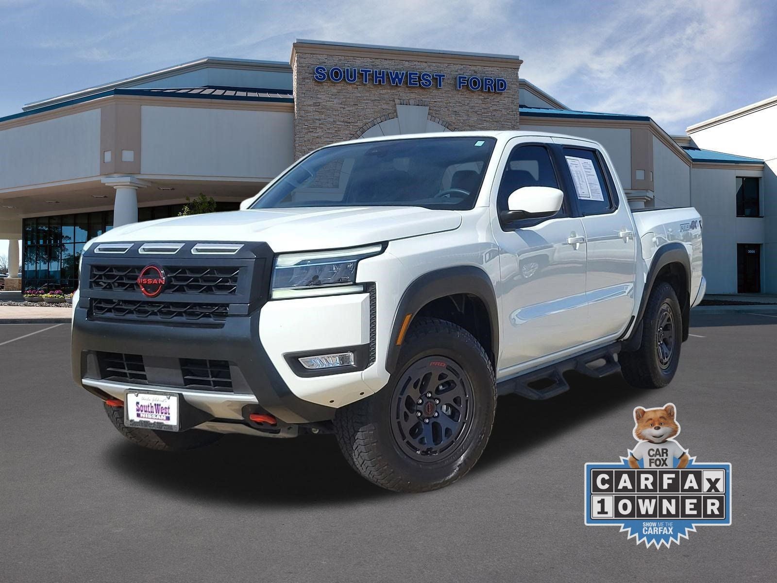 2025 Nissan Frontier PRO-4X in Glacier White — front three-quarter view