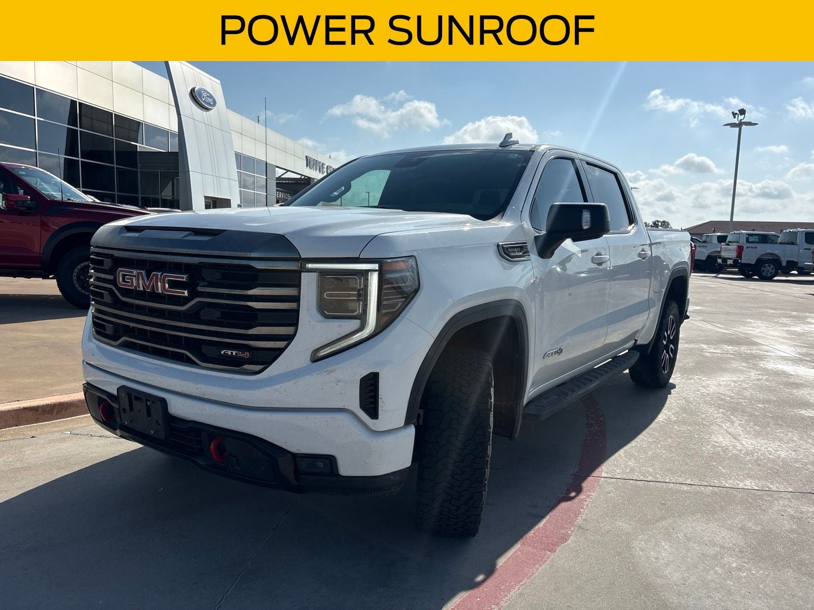 2022 GMC Sierra 1500 AT4 in Summit White — front three-quarter view